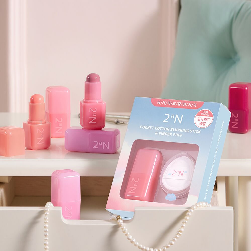 2an Pocket Cotton Blurring Stick displayed on a vanity table with packaging and multiple shades of product visible.