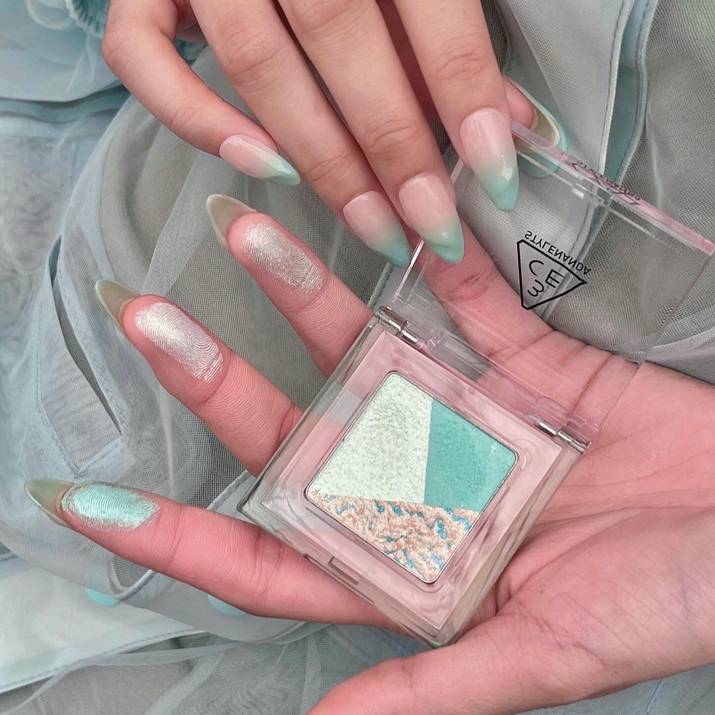 3CE Color Grid Eyeshadow in mint hues displayed on a hand with matching nail art