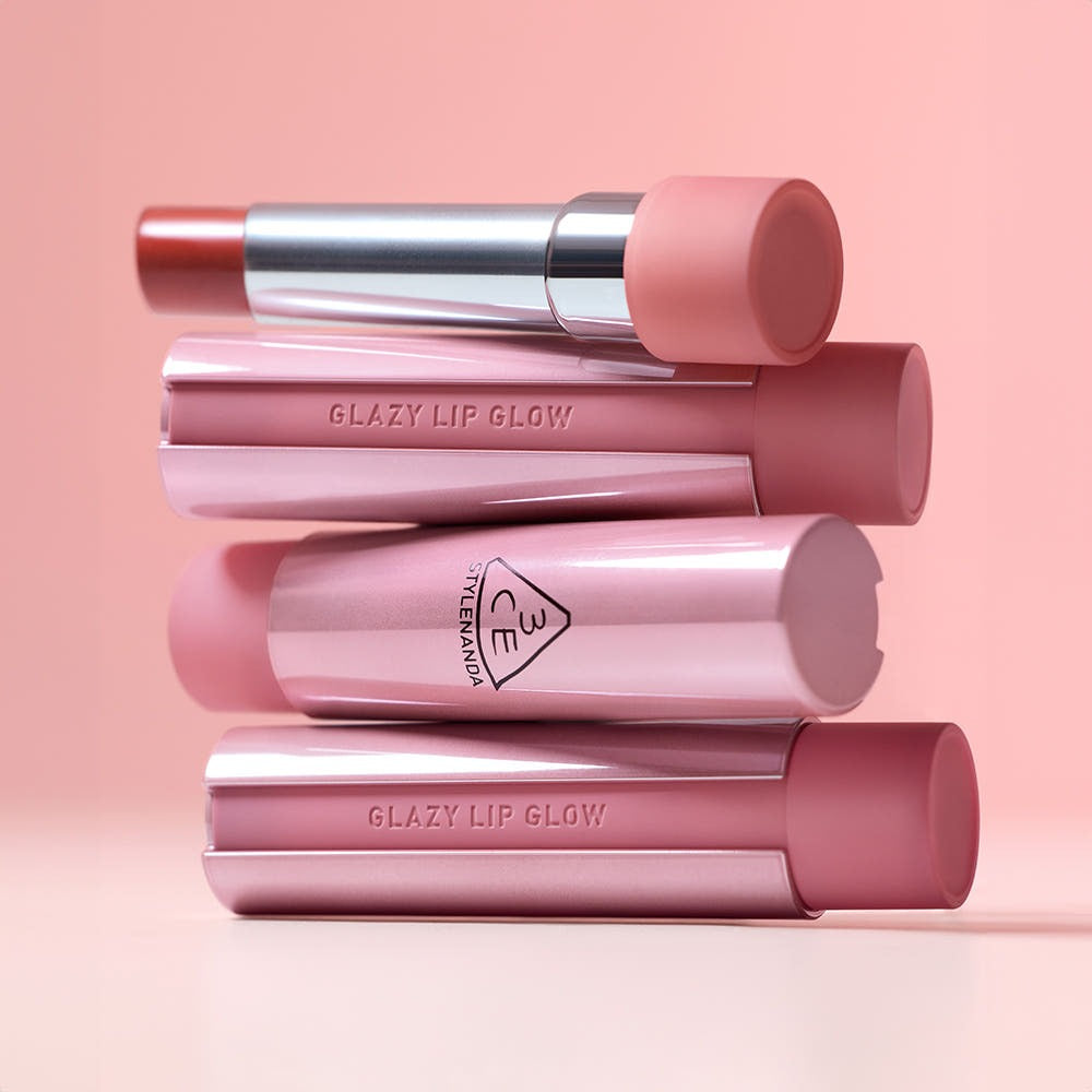 3CE Glaze Lip Glow 3.2g in various shades against a pink background, showcasing elegant design and vibrant colors.