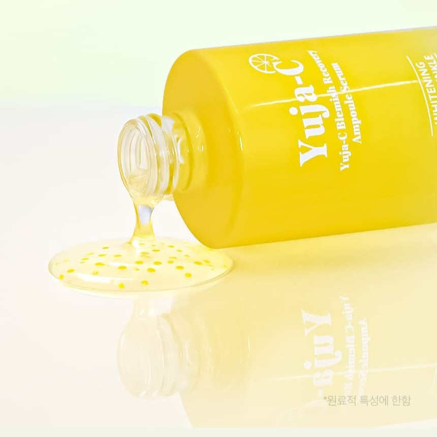 3W CLINIC Yuja C Blemish Recovery Ampoule Serum 100ml bottle with serum spilling out, showcasing the product's packaging and texture.
