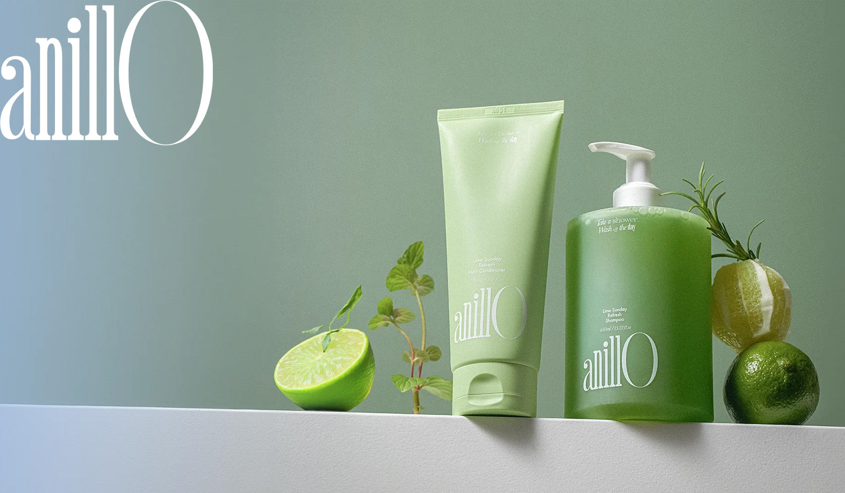 Anillo skincare products displayed with fresh limes and greenery on a minimalist green backdrop.