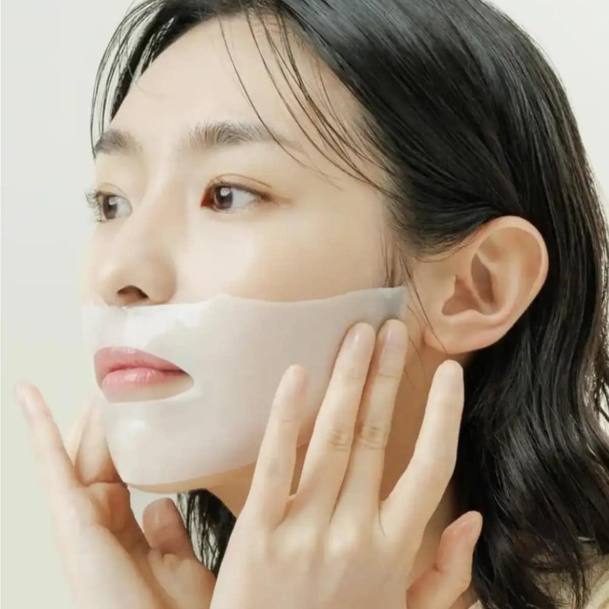 Woman applying ABIB Collagen Gel Mak Jericho Rose Jelly 10sheets to face