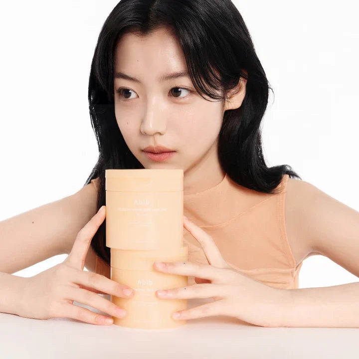 ABIB Glutathiosome Dark Spot Pad Vita Touch 60 EA displayed with woman holding product jars.