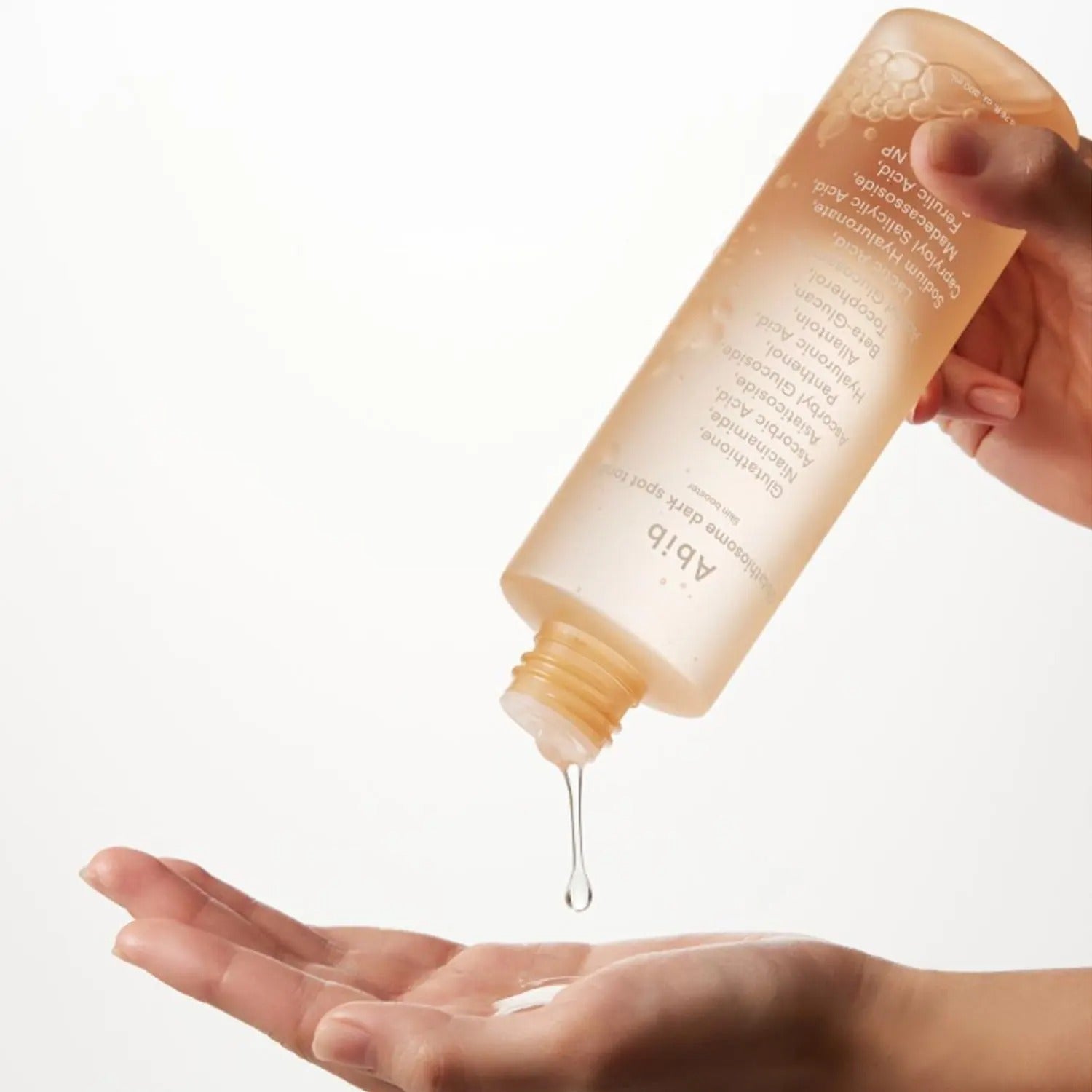 ABIB Glutathiosome Dark Spot Toner Skin Booster 200ml being poured onto a hand for skincare routine.