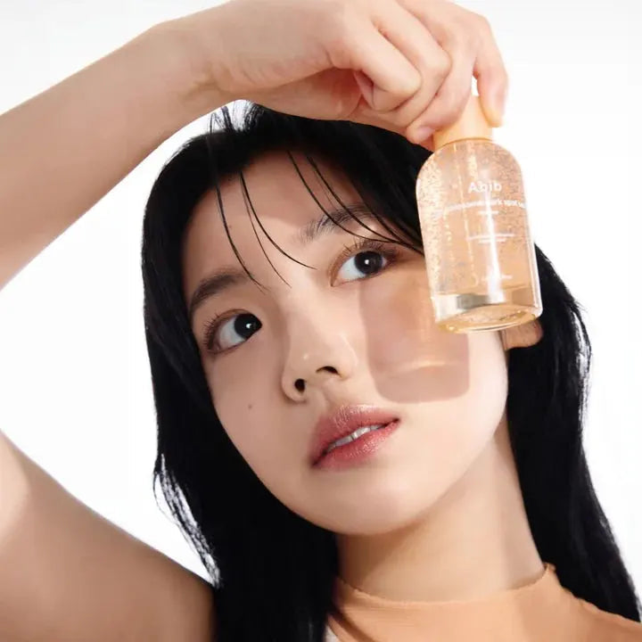 Woman holding ABIB Glutathiosome Spot Serum Vita Drops 50ml.