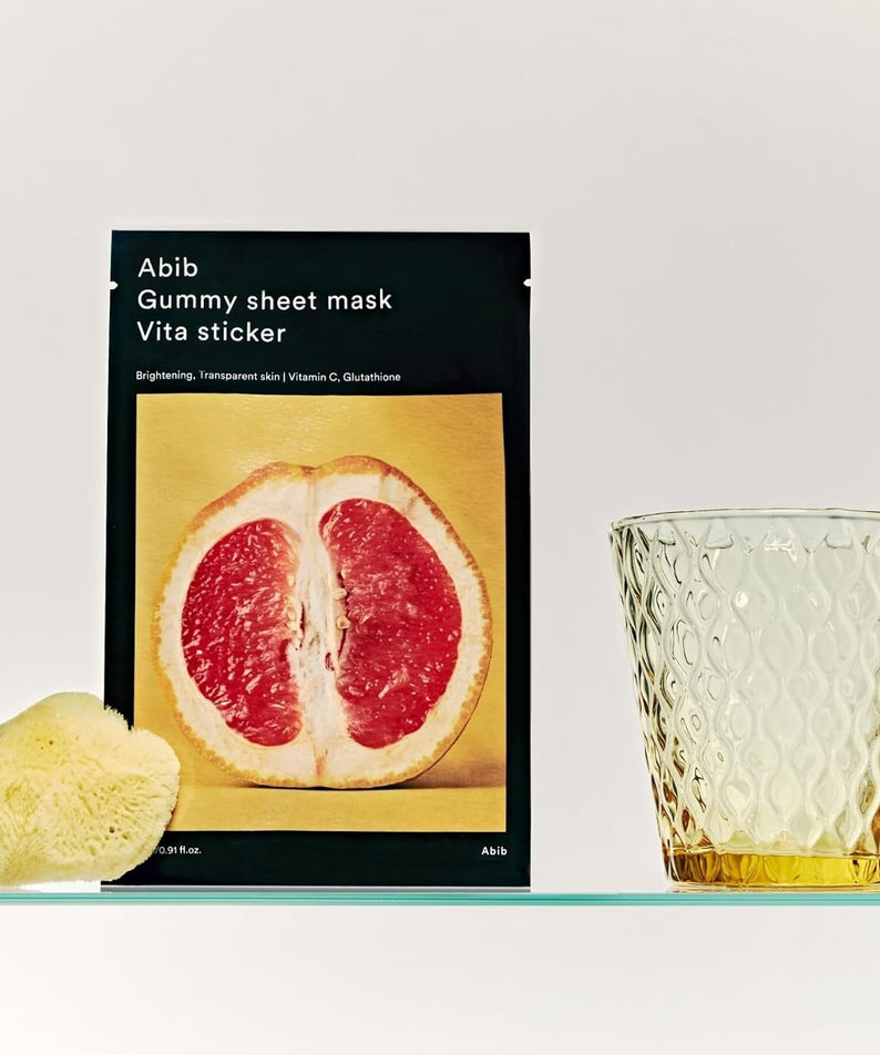 ABIB Gumy Sheet Mask Vita Sticker 10 sheets with grapefruit slice and glass on display, skincare product for brightening.