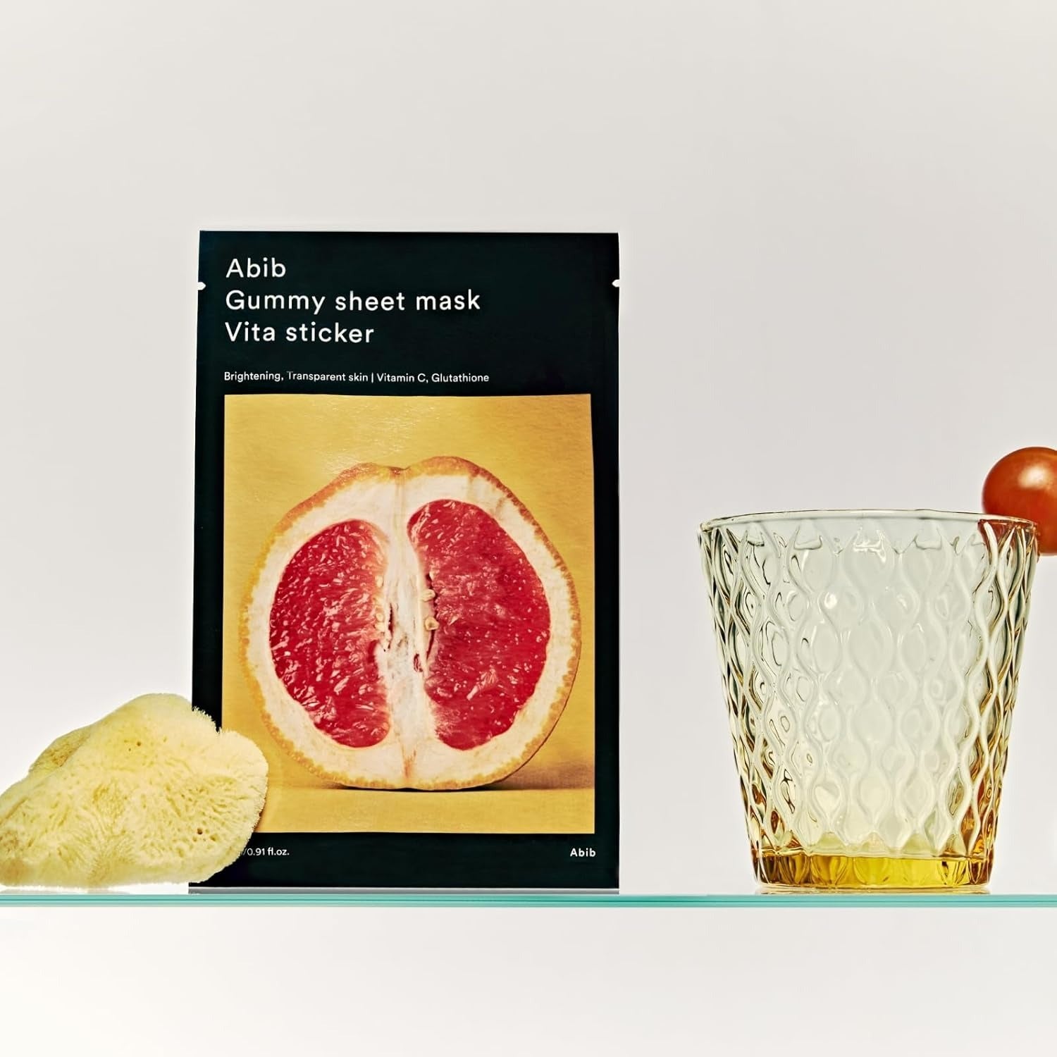 ABIB Gumy Sheet Mask Vita Sticker 10 sheets with grapefruit slice and glass on display, skincare product for brightening.