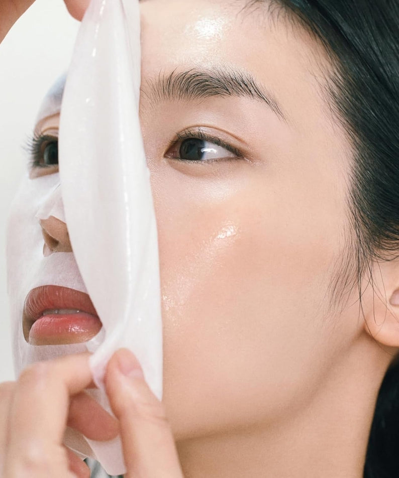 Applying ABIB Gumy Sheet Mask Vita Sticker 10 sheets on face