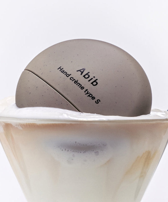 ABIB Hand Cream 3 Types displayed on a creamy dessert in a glass.