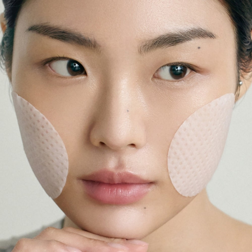 Close-up of woman using ABIB Jericho Rose Collagen Pad Firming Touch 60 Pads for skincare