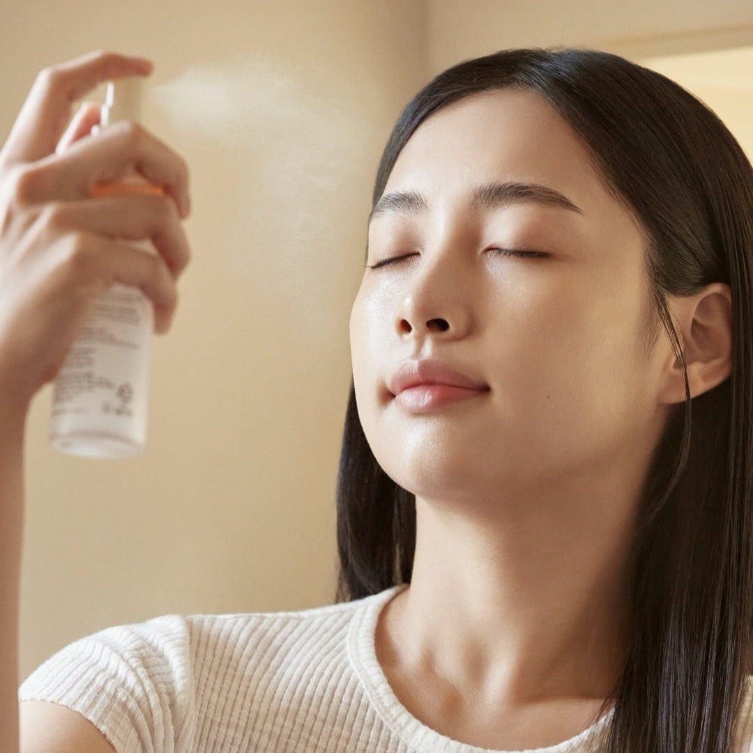 Woman using ABIB Jericho Rose Mist Serum Glow Spray 100ml for a refreshing skincare routine.