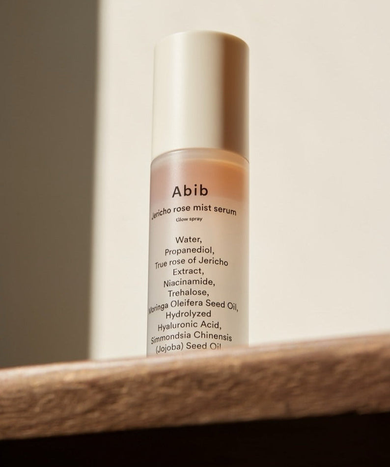 ABIB Jericho Rose Mist Serum Glow Spray 100ml on a wooden surface in natural light