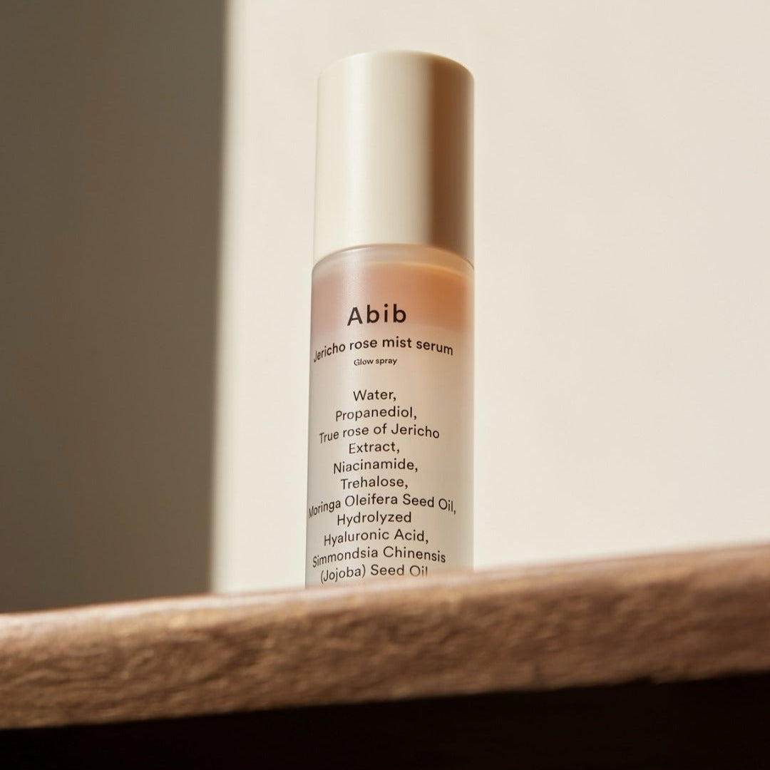 ABIB Jericho Rose Mist Serum Glow Spray 100ml on a wooden surface in natural light