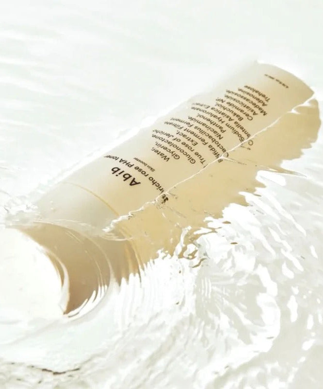 ABIB Jericho Rose PHA Toner Skin Booster 200ml submerged in water showcasing its packaging and hydrating essence effect.