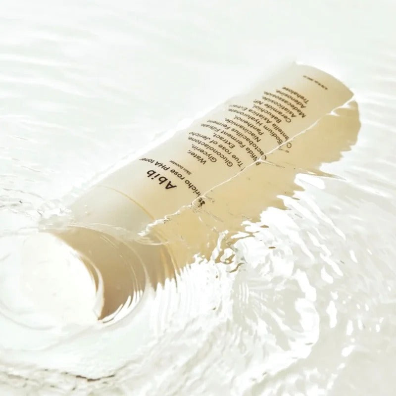 ABIB Jericho Rose PHA Toner Skin Booster 200ml submerged in water showcasing its packaging and hydrating essence effect.