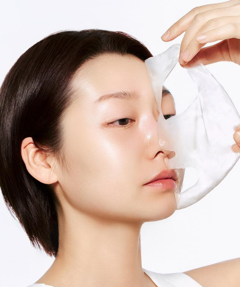 Person using ABIB Lifting Collagen Wrapping Mask Resurrection Film 100ml, applying face mask for skincare routine