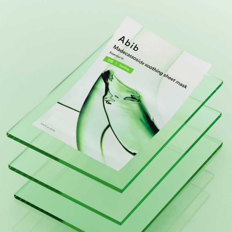 ABIB Madecassoside Soothing Sheet Essential Fit displayed on green glass layers