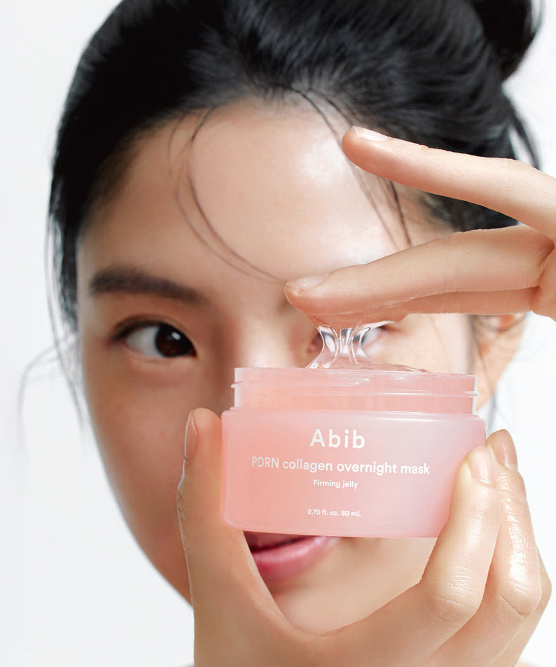 Woman holding ABIB PDRN Collagen Overnight Mask Firming Jelly 80ml in her hands.