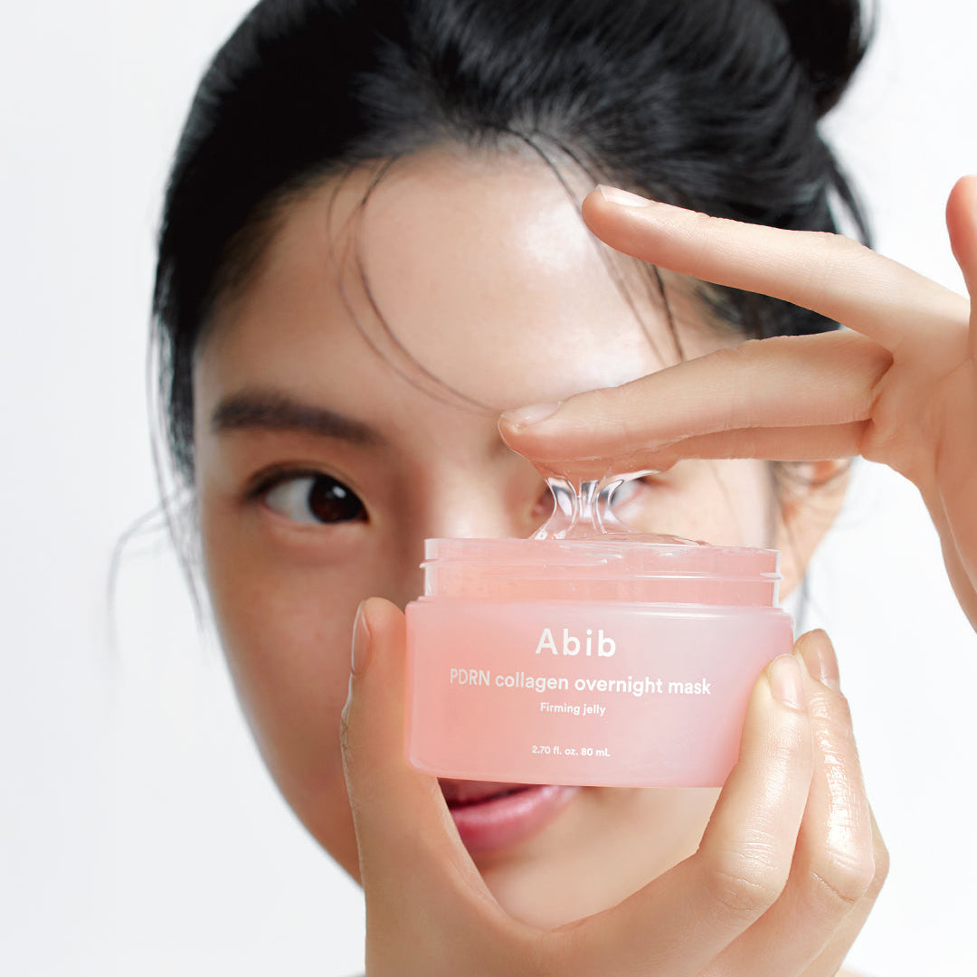 Woman holding ABIB PDRN Collagen Overnight Mask Firming Jelly 80ml in her hands.