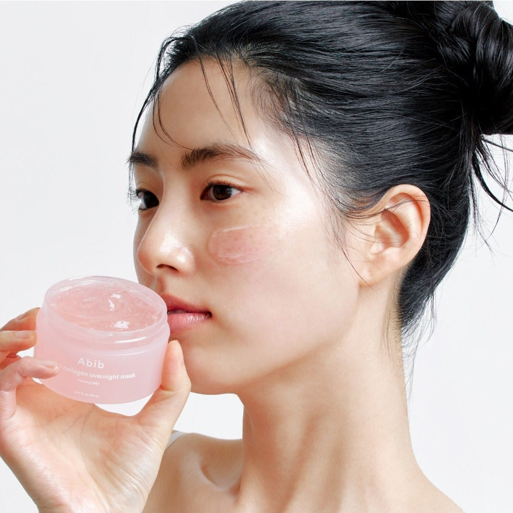Woman applying ABIB PDRN Collagen Overnight Mask Firming Jelly 80ml to her face, showcasing skincare benefits.
