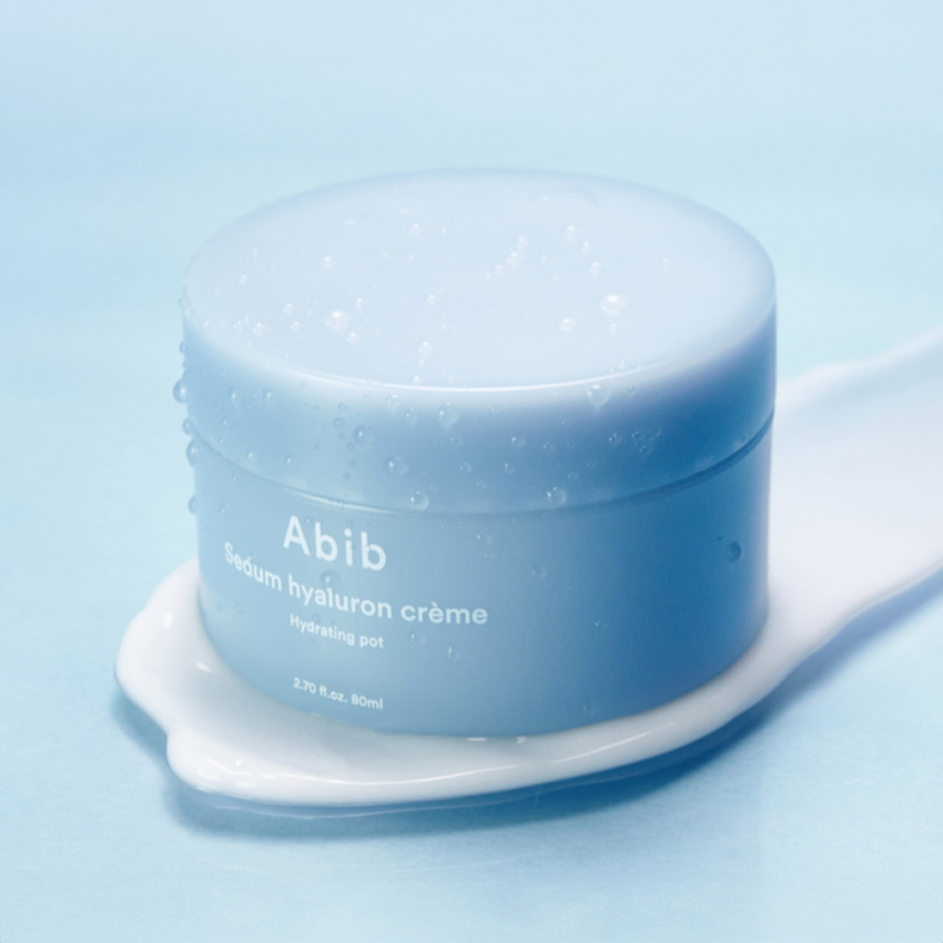 ABIB Sedum Hyaluron Creme Hydrating Pot 80ml product image on a blue background with droplets.