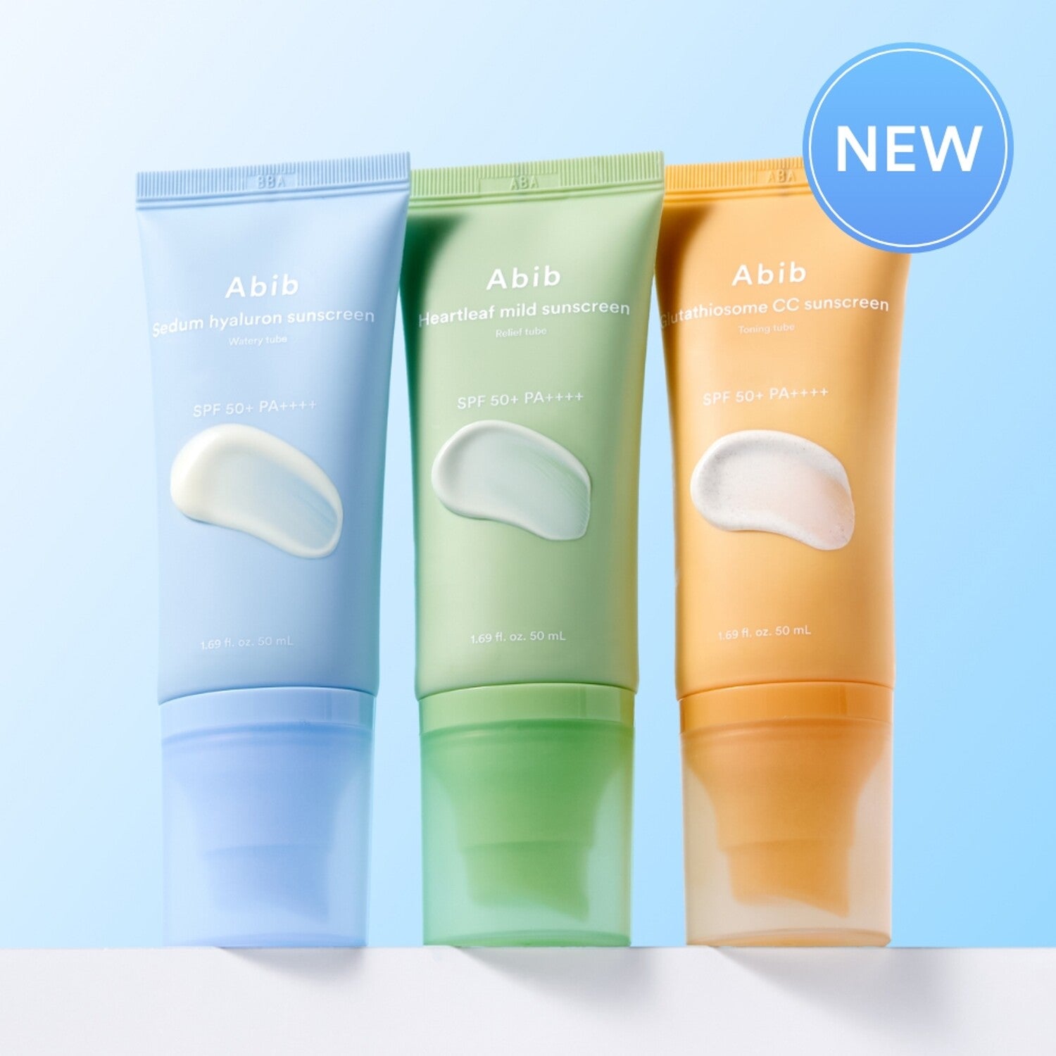 ABIB Sunscreen Tube 50ml 3 Types displayed in different colors against a blue background, highlighting new skincare product release.