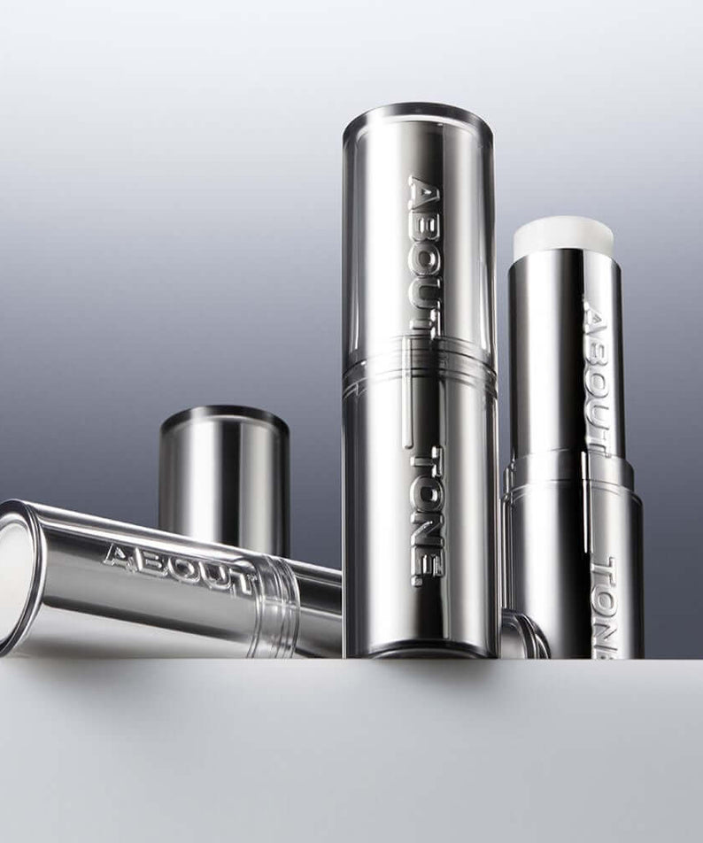 ABOUT TONE Blur Lasting Stick Primer in sleek silver packaging for a flawless finish.