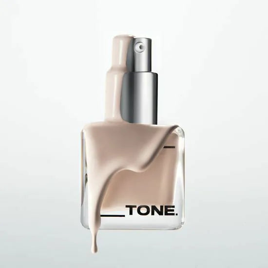 ABOUT TONE Skin Layer Fit Foundation bottle with liquid foundation dripping down, showcasing smooth coverage and flawless finish.