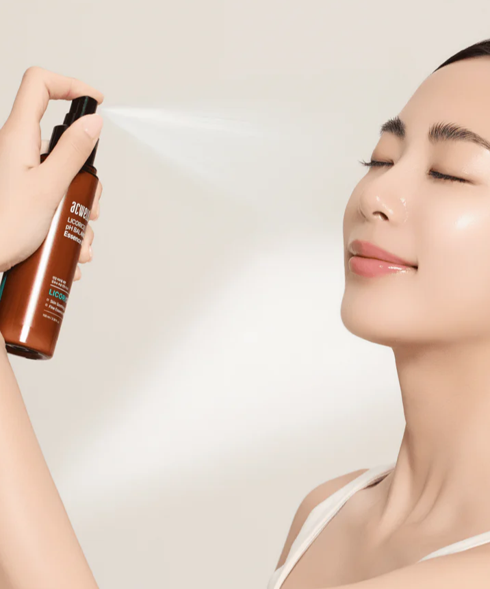 Woman using ACWELL Licorice pH Balancing Essence Mist 100ml on her face for hydration and skin balance.