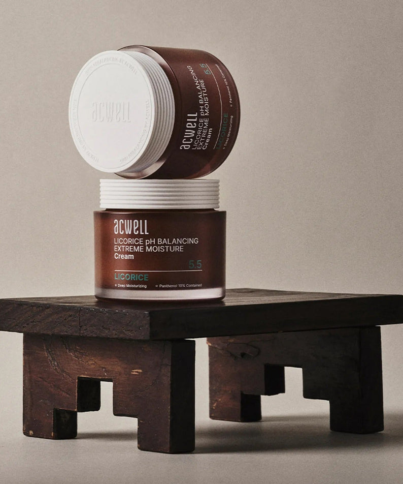 Two jars of ACWELL Licorice pH Balancing Extreme Moisture Cream 55ml on a wooden stand