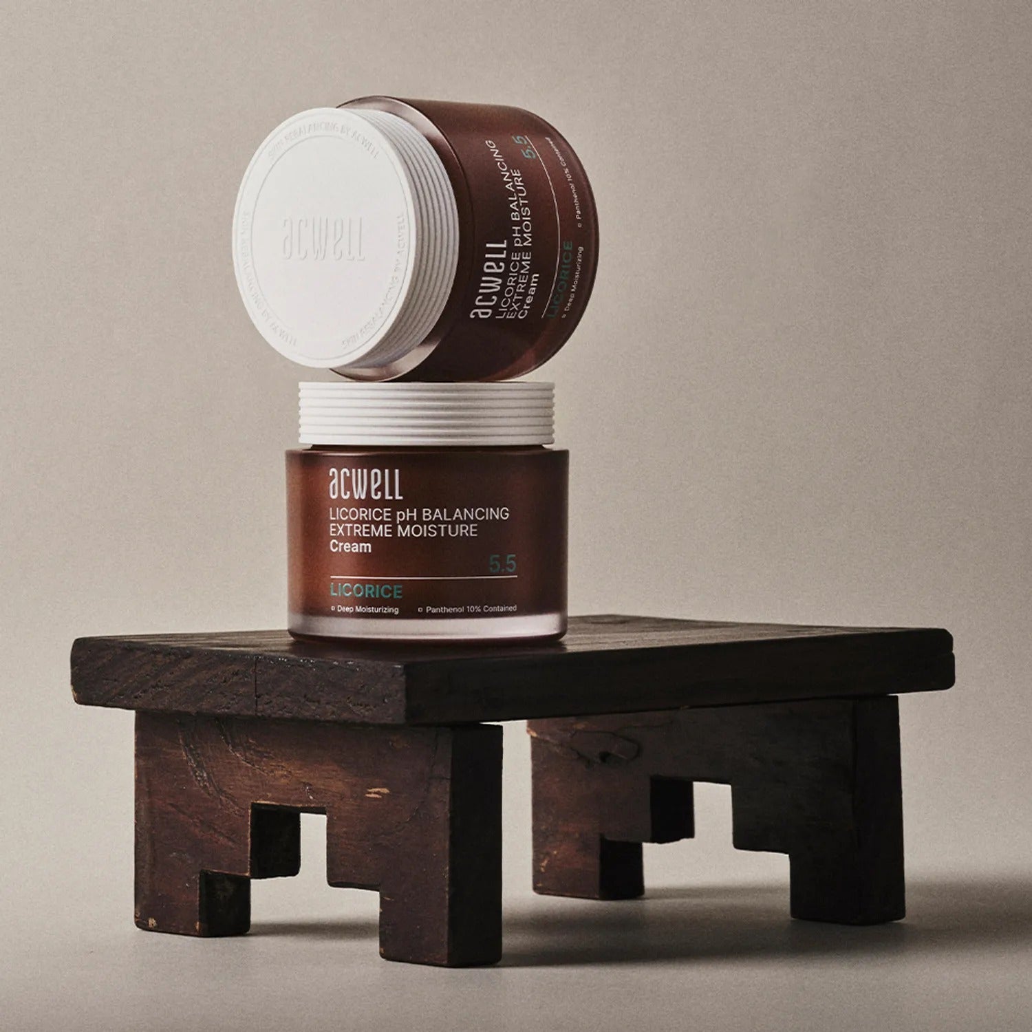 Two jars of ACWELL Licorice pH Balancing Extreme Moisture Cream 55ml on a wooden stand