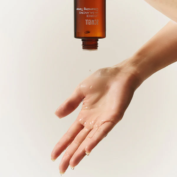 ACWELL Licorice pH Balncing Cleansing Toner 150ml being poured onto hand for skincare routine.
