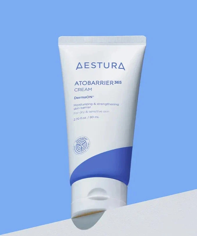 AESTURA Atobarrier 365 Cream 80ml tube on display against a blue background.