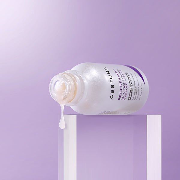 AESTURA Rizederm 365 Skin Tightening Capsule Serum 30ml bottle displayed on a purple background with serum pouring out.