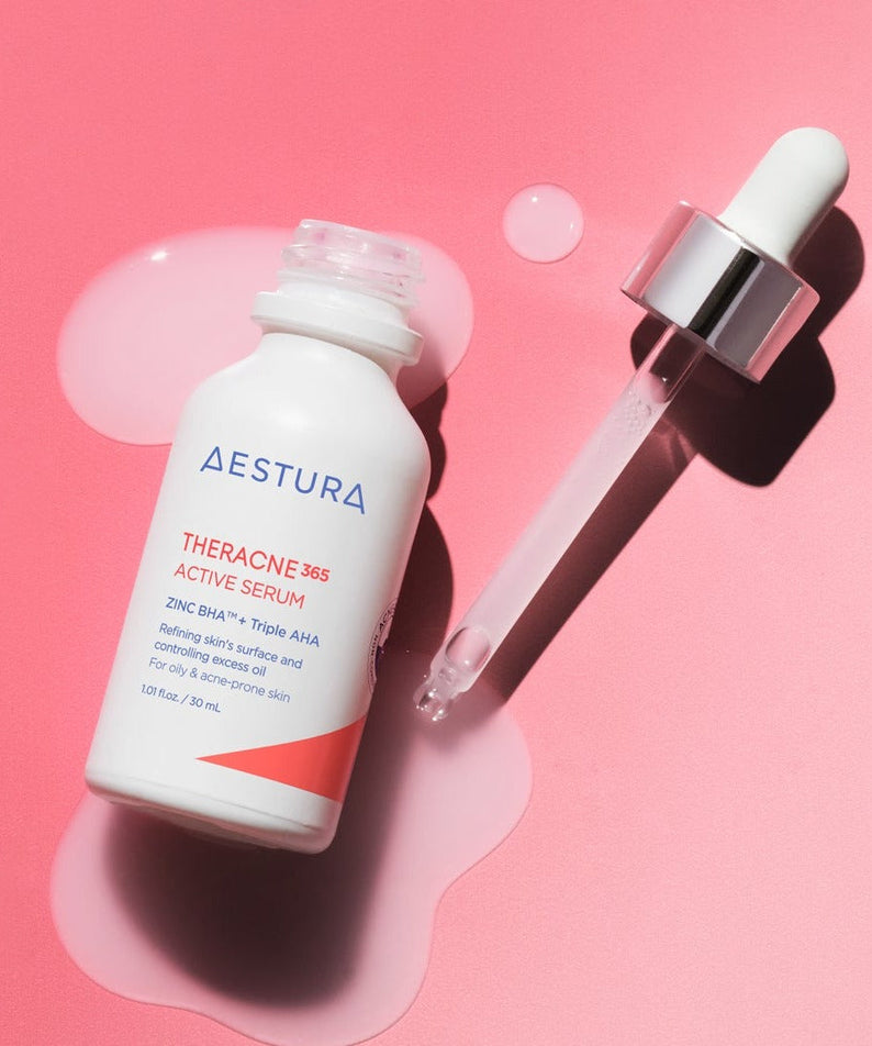 Bottle of AESTURA Theracne 365 Active Serum 30ml with dropper on pink background