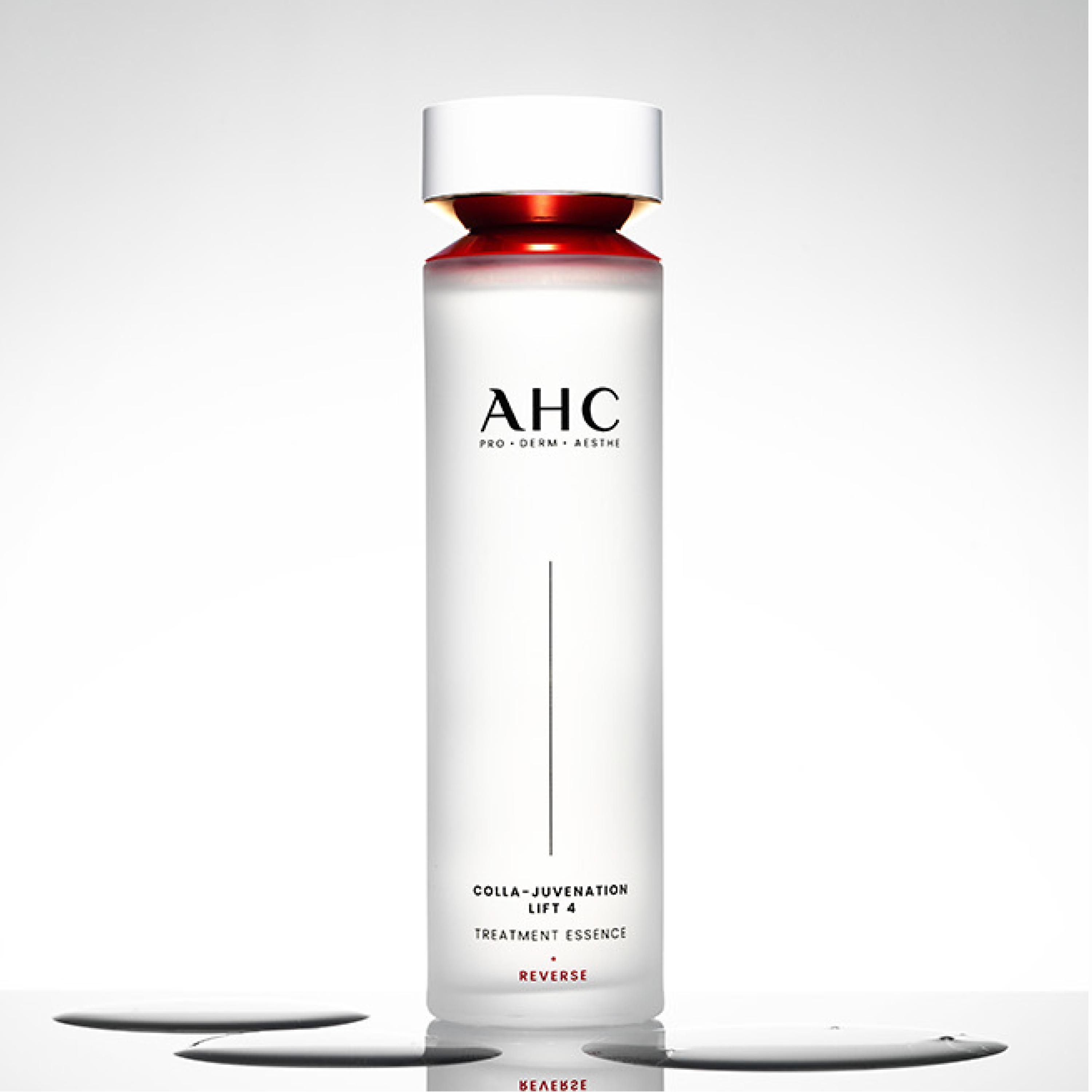 AHC Cola Juvenation Lift 4 Treatment Essence 130ml bottle on a reflective surface, highlighting skincare benefits and elegant design.