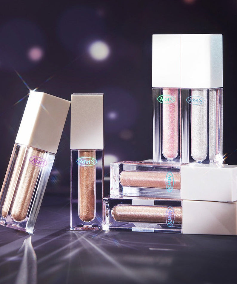 ALL MY THING Kiss Your Eye Glitter Liquid Eyeshadow in various shades displayed on a reflective surface.