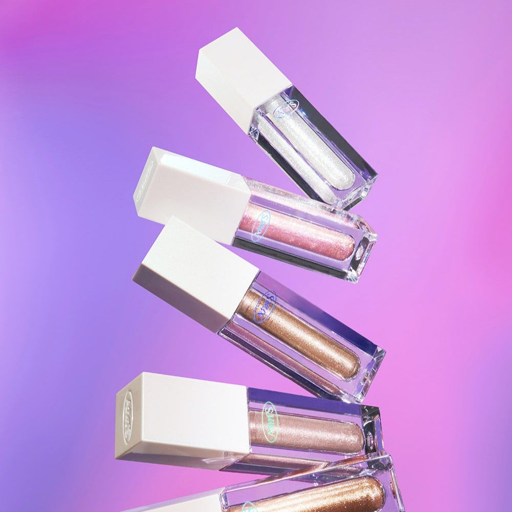 ALL MY THING Kiss Your Eye Glitter Liquid Eyeshadow variety on display against pink and purple gradient background