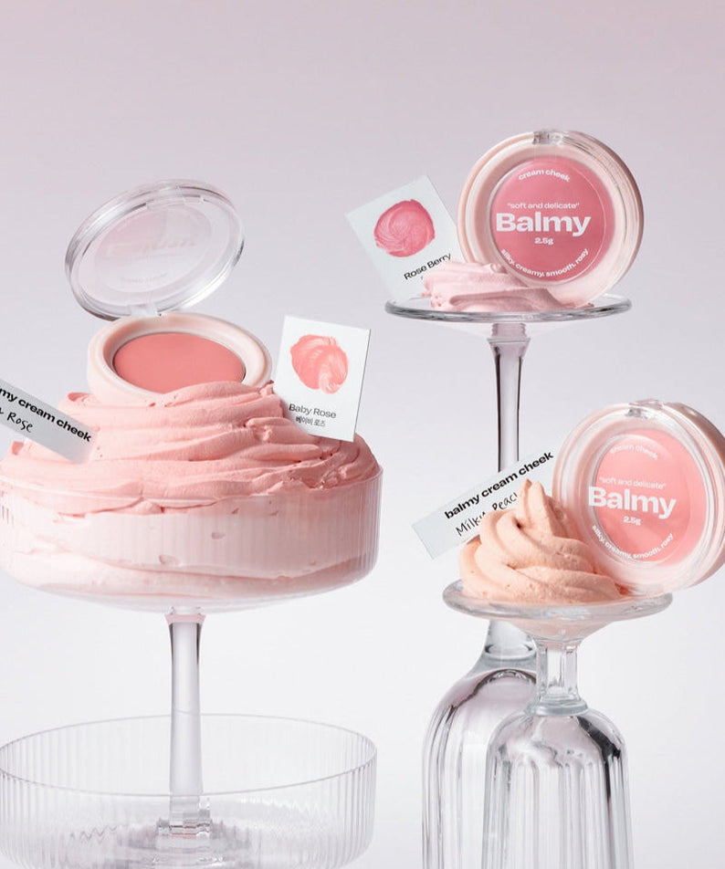ALTERNATIVE STEREO Balmy Cream Cheek in elegant packaging, displayed on glass stands against a soft pink background.