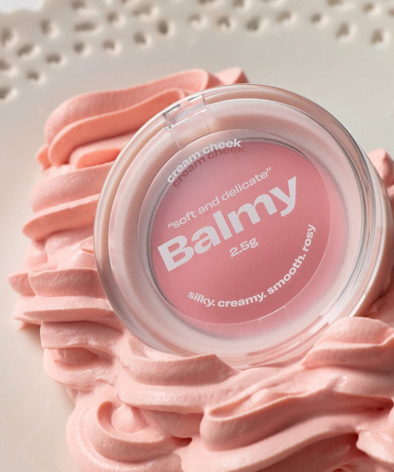ALTERNATIVE STEREO Balmy Cream Cheek on decorative pink cream swirls, highlighting its smooth and delicate texture.