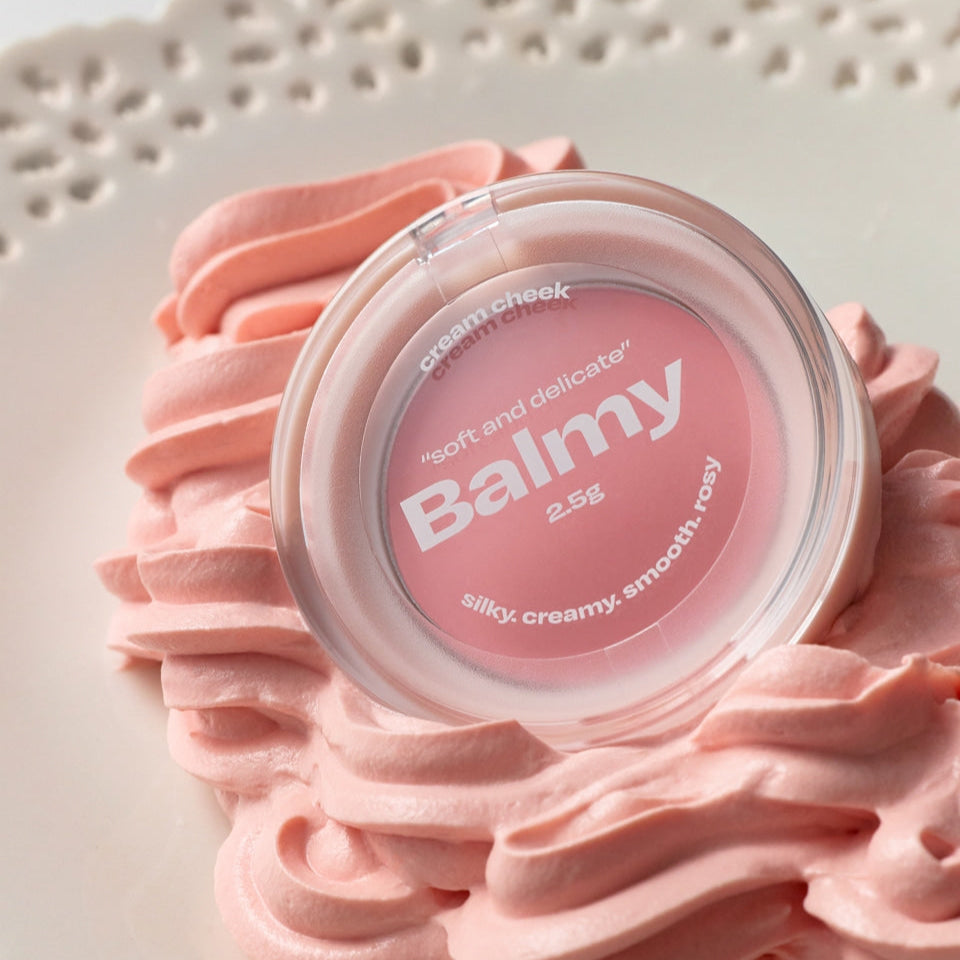 ALTERNATIVE STEREO Balmy Cream Cheek on decorative pink cream swirls, highlighting its smooth and delicate texture.