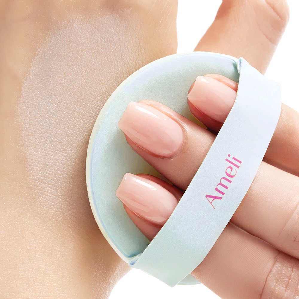 Applying AMELI Complement Series Cushion SPF42 PA++ Green with puff on skin, highlighting smooth finish and sun protection benefits
