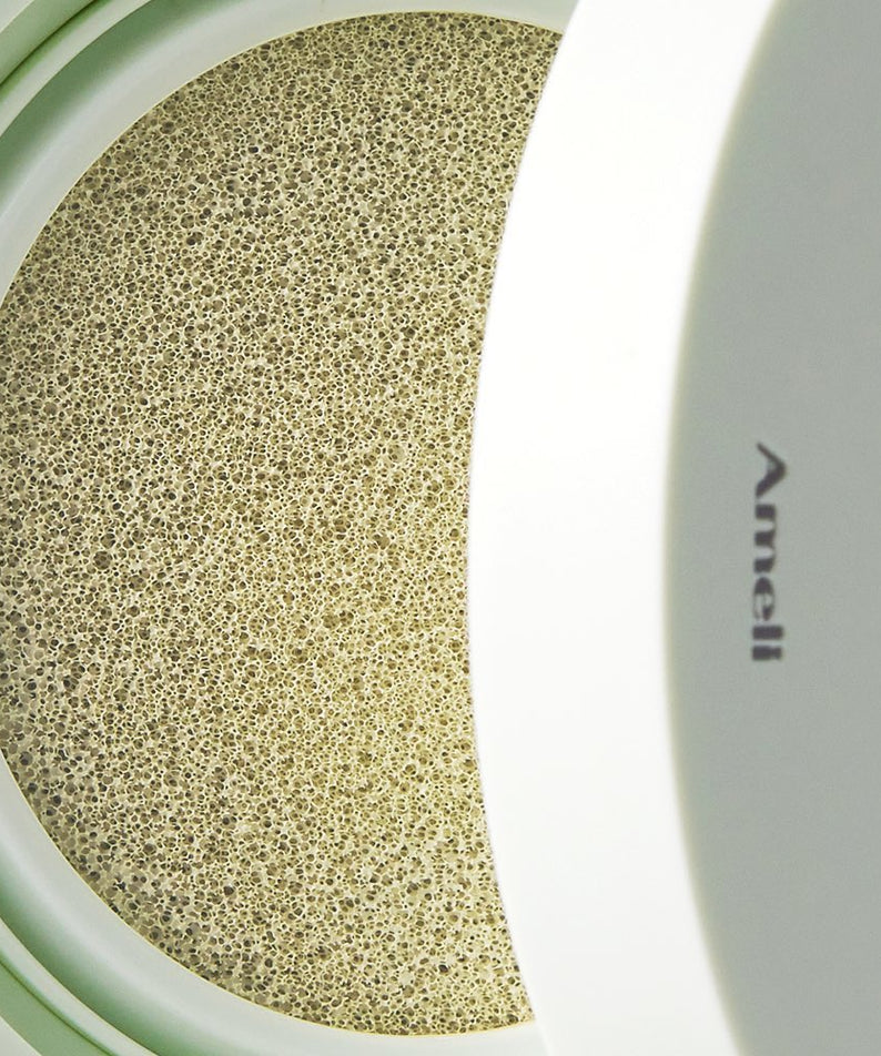 AMELI Complement Series Cushion SPF42 PA++ Green in open compact showcasing cushion texture