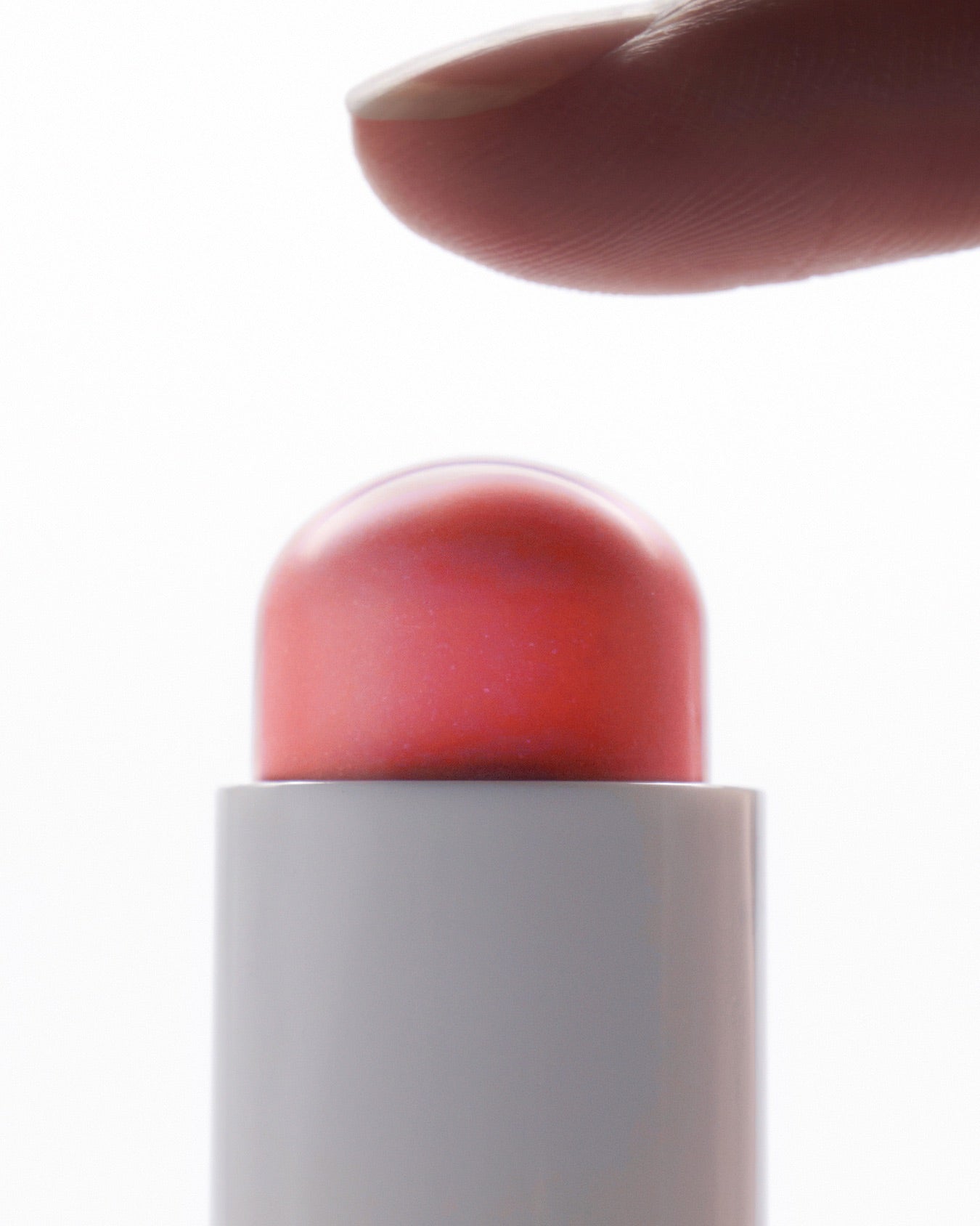 Finger touching AMELI Night Series Touch Balm, a luxury skincare product for nighttime use.