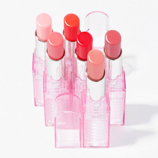 AMUSE Dew Balm collection of colorful lip balms in pink cases for vibrant, hydrating lips.
