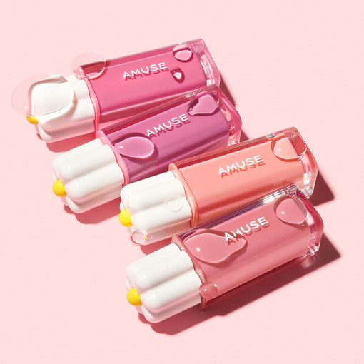 AMUSE Dew Tint collection in various shades on a pink background, featuring vibrant colors and sleek packaging.
