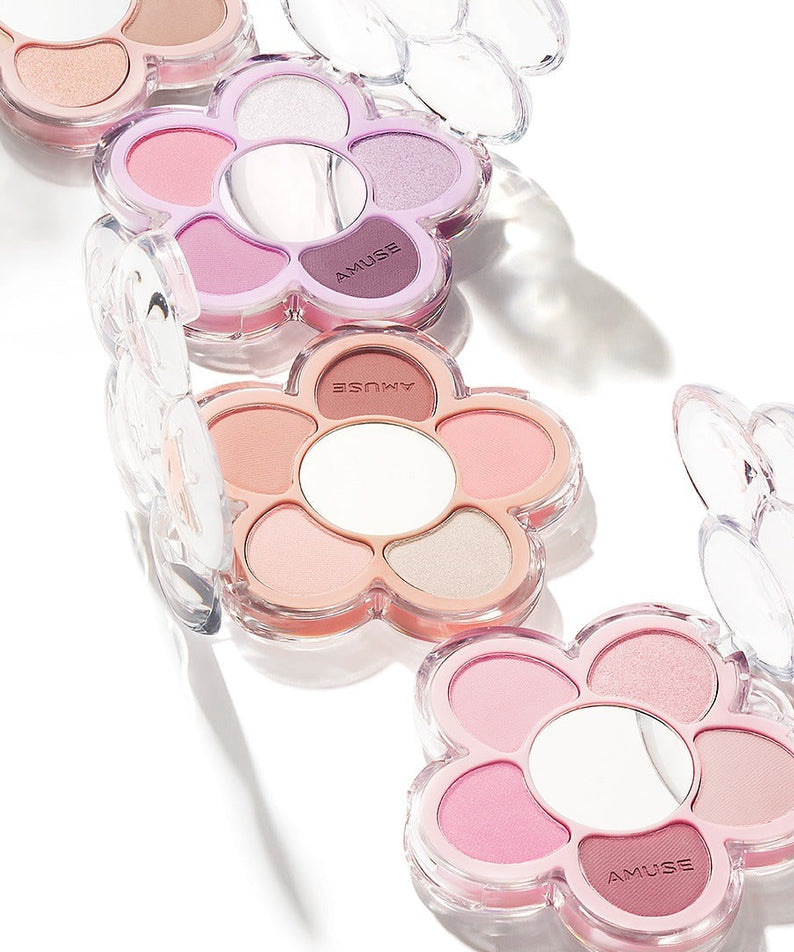 AMUSE Flora Eye Palette in flower-shaped packaging with assorted shades, showcasing vibrant and pastel colors.