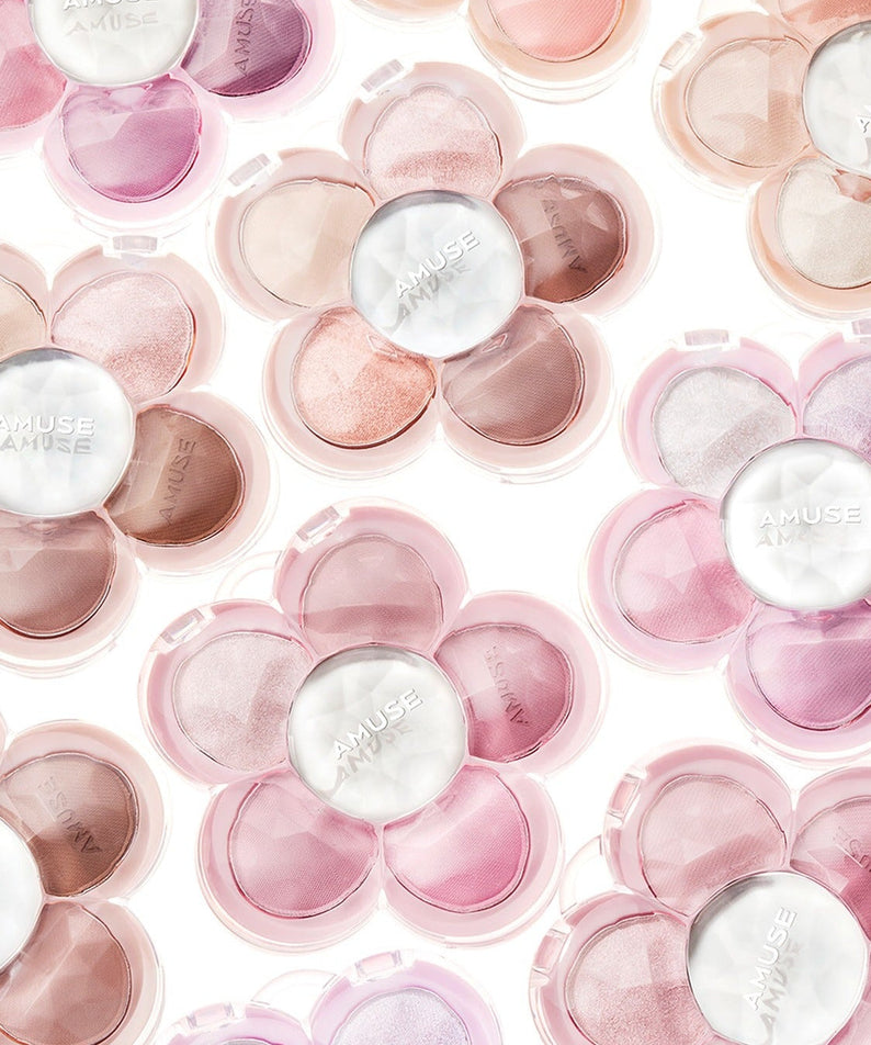 Various AMUSE Flora Eye Palette floral-shaped compacts with pink, nude, and neutral shades.