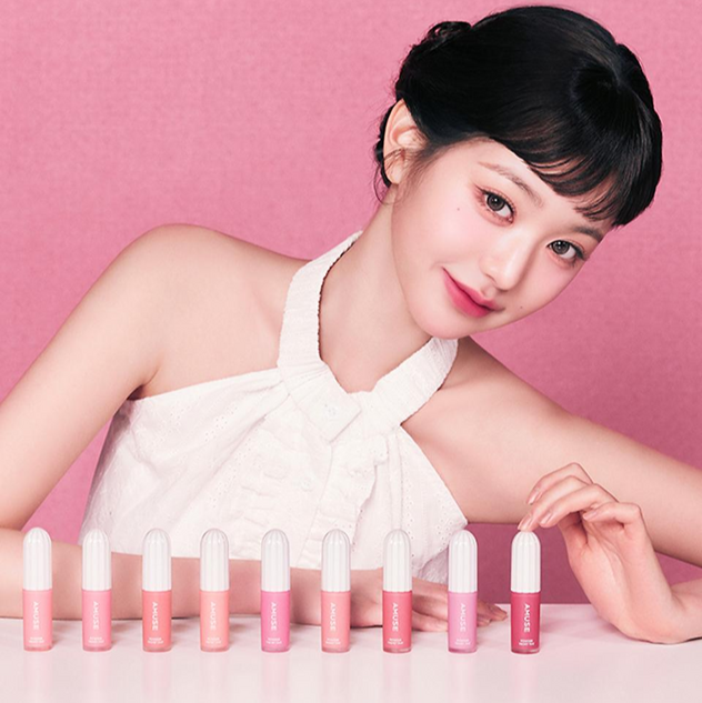 AMUSE Powder Velvet Tint collection displayed with model on pink background