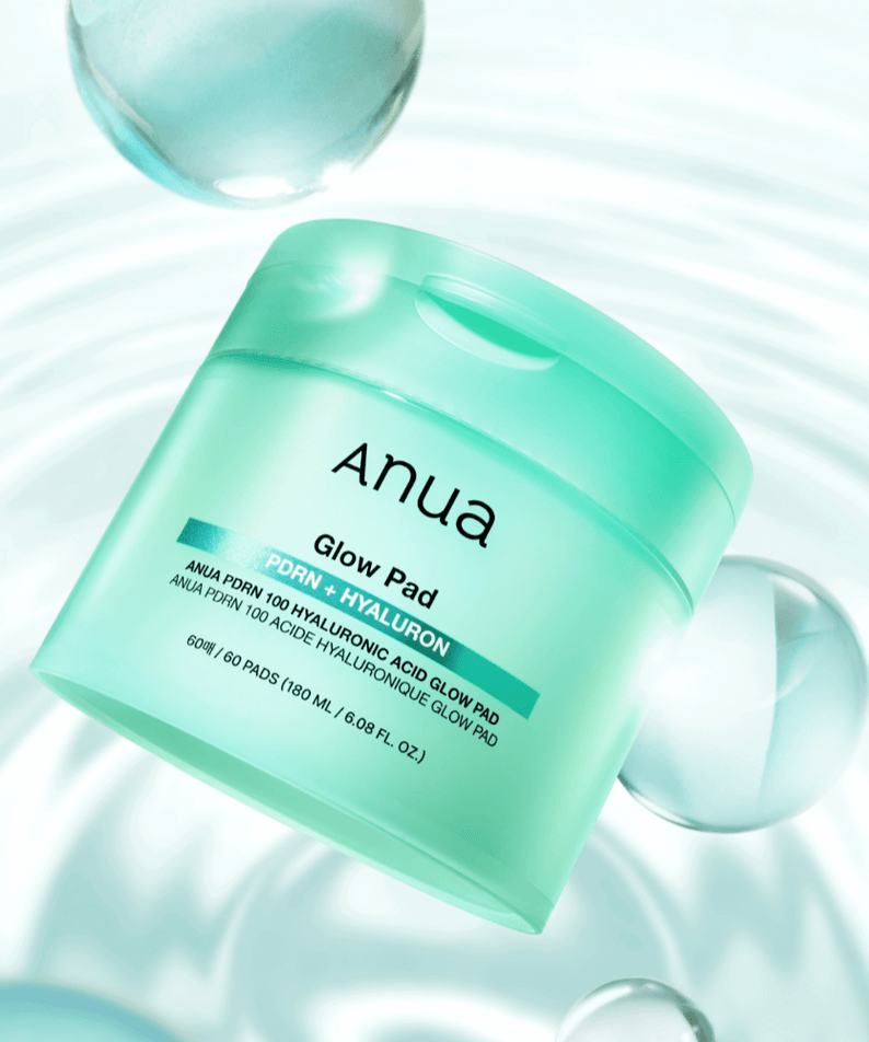 ANUA PDRN 100 Hyaluronic Acid Glow Pad in a mint green container, featured on a light reflective background.